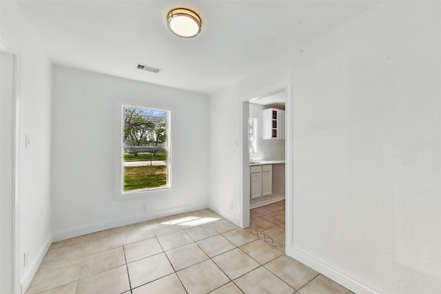 2430 5th Ave N, Texas City, TX 77590 - empty room with light tile patterned floors, visible vents, and baseboards