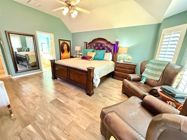 bedroom with light wood-type flooring, lofted ceiling, multiple windows, and visible vents