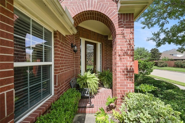 doorway to property with brick siding