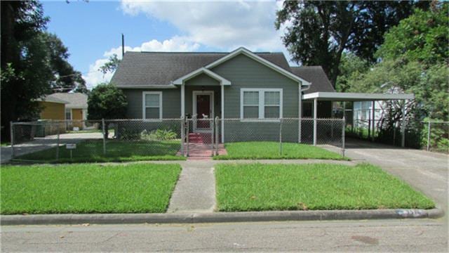 view of front of home featuring a fenced front yard, a front yard, a gate, a carport, and driveway