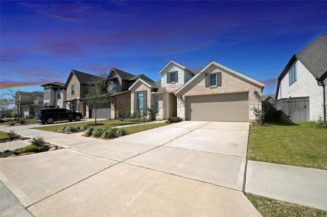 view of front facade with a garage, brick siding, driveway, a yard, and a residential view