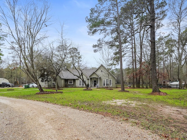 view of front of home with a front yard and fence