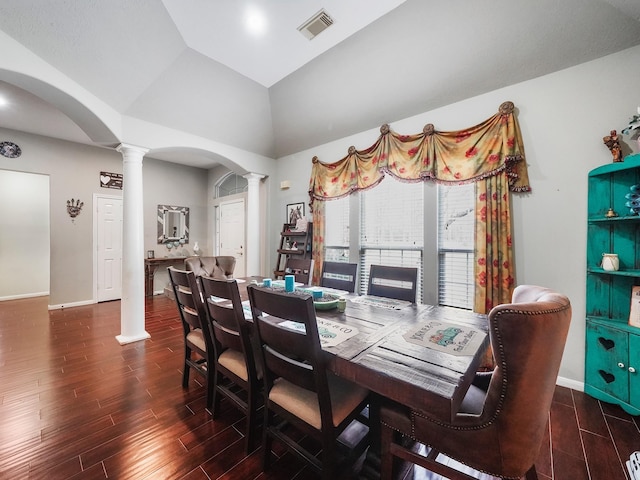 dining room with dark wood-style floors, decorative columns, visible vents, and arched walkways