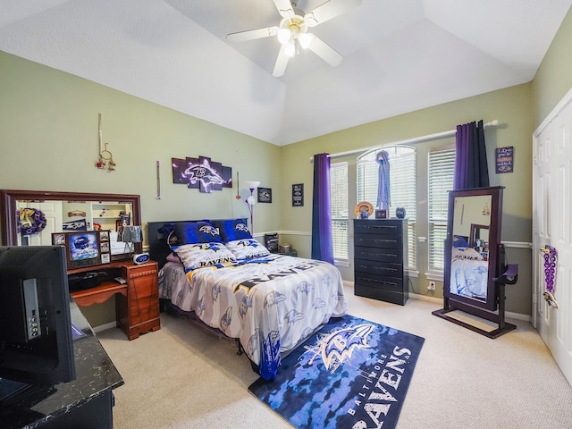 bedroom with a ceiling fan, lofted ceiling, light carpet, and baseboards