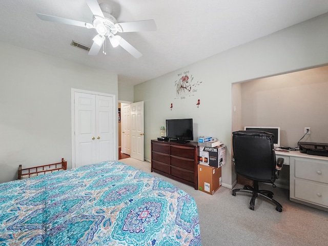 bedroom with ceiling fan, a closet, visible vents, and light colored carpet