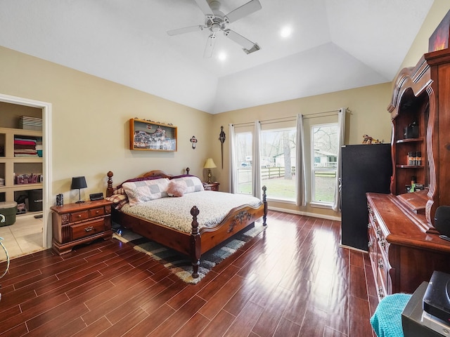 bedroom featuring vaulted ceiling, dark wood finished floors, visible vents, and a ceiling fan