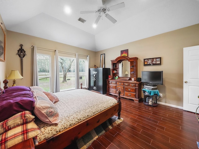 bedroom with dark wood-style flooring, a ceiling fan, visible vents, vaulted ceiling, and baseboards