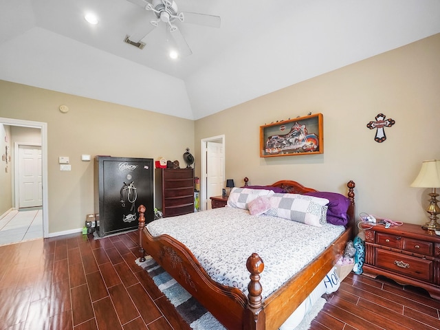 bedroom featuring wood finish floors, lofted ceiling, visible vents, a ceiling fan, and baseboards