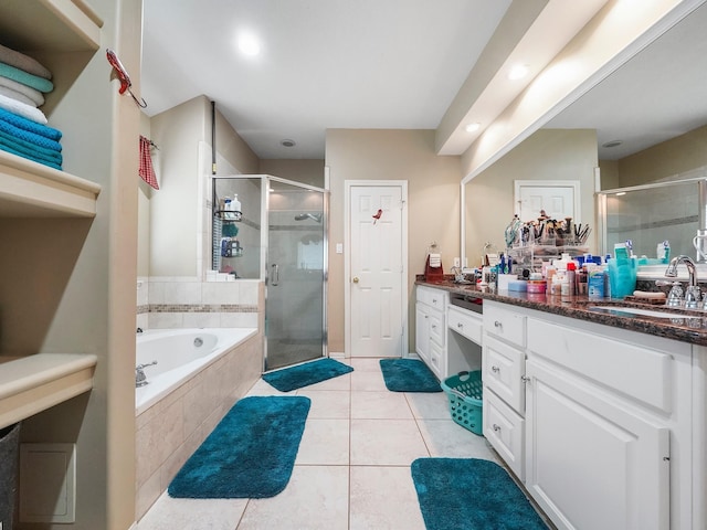 full bath with a garden tub, a shower stall, vanity, and tile patterned floors