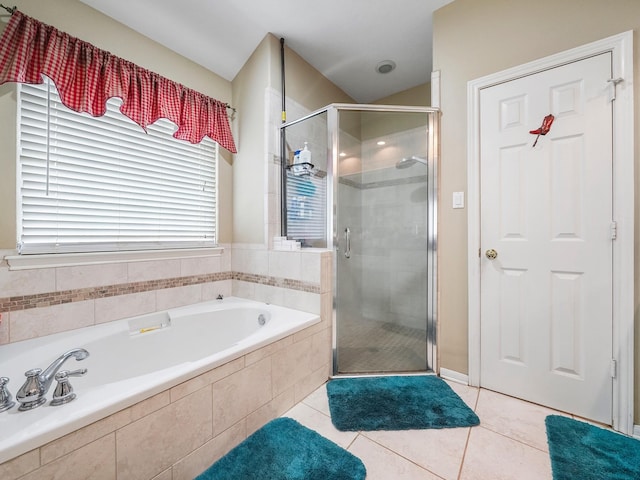 bathroom featuring a stall shower, tile patterned flooring, and a garden tub