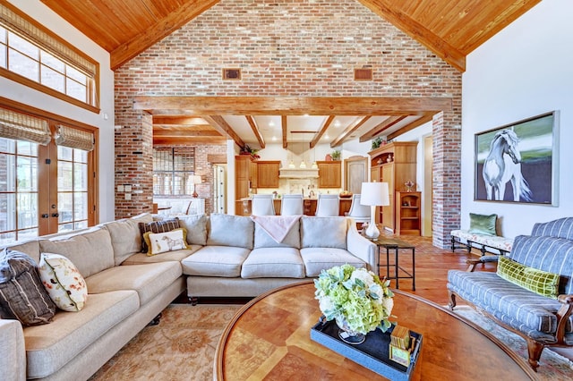 living area with high vaulted ceiling, wood ceiling, french doors, beam ceiling, and light wood finished floors