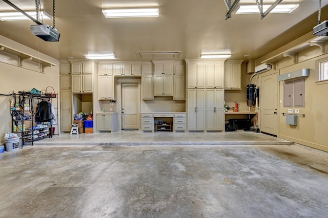 garage with a wall mounted air conditioner and a garage door opener