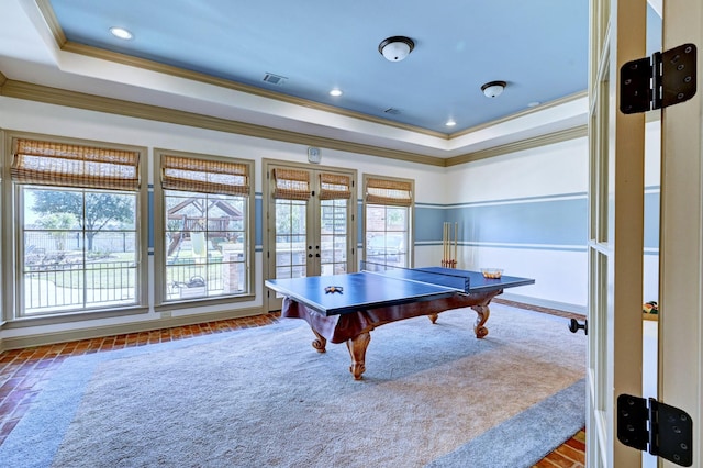 recreation room with visible vents, a tray ceiling, crown molding, french doors, and a healthy amount of sunlight