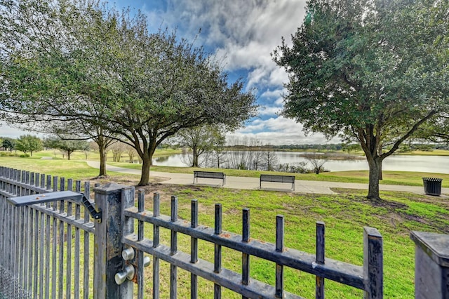 view of yard with a water view and fence