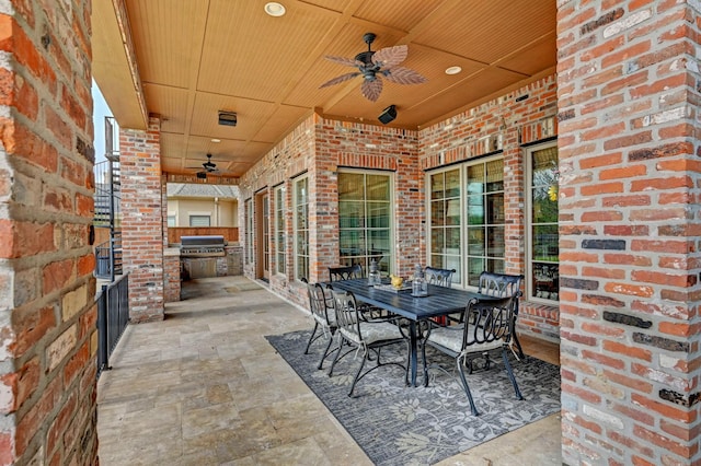 view of patio featuring outdoor dining space, area for grilling, ceiling fan, and an outdoor kitchen