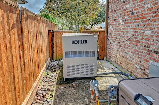 details with a power unit, brick siding, and fence