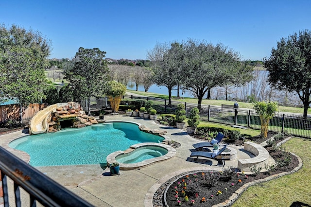 view of pool featuring a patio, a fenced backyard, a water view, a water slide, and a pool with connected hot tub