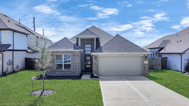 view of front facade featuring a shingled roof, concrete driveway, an attached garage, a front lawn, and brick siding