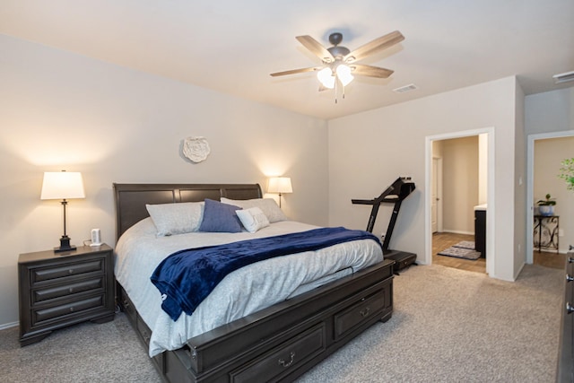 bedroom featuring ceiling fan, visible vents, and light colored carpet