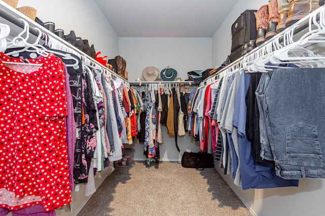 spacious closet with vaulted ceiling and carpet