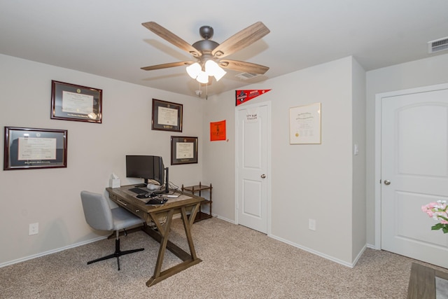 office space with light carpet, a ceiling fan, visible vents, and baseboards