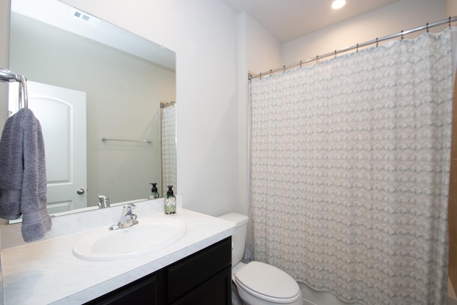 full bathroom featuring toilet, visible vents, and vanity