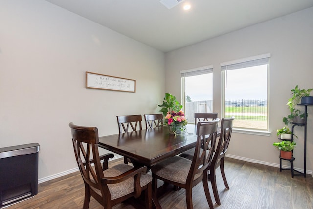 dining area featuring dark wood finished floors and baseboards