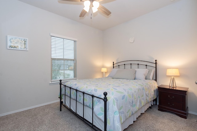 bedroom with light carpet, baseboards, and a ceiling fan