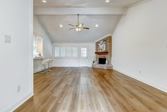 unfurnished living room with vaulted ceiling with beams, a ceiling fan, baseboards, and a fireplace
