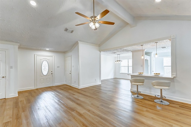 entryway featuring a ceiling fan, baseboards, visible vents, and light wood finished floors
