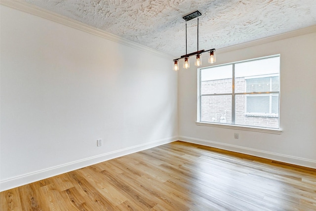 unfurnished room featuring crown molding, a textured ceiling, baseboards, and light wood-type flooring
