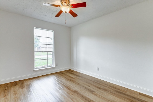 unfurnished room featuring a ceiling fan, baseboards, and light wood finished floors