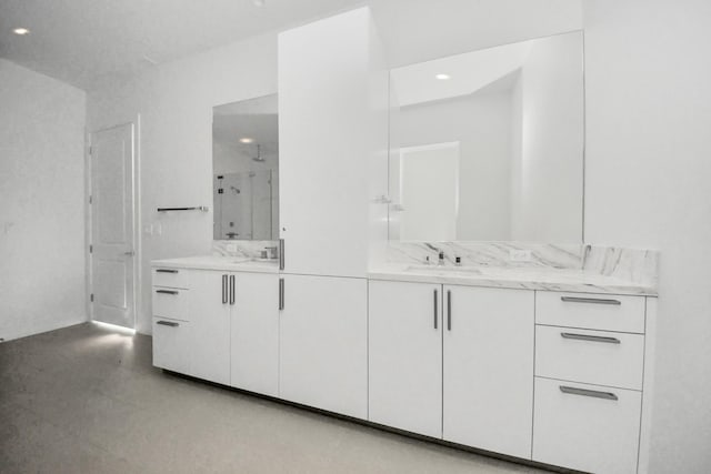 bathroom featuring recessed lighting, a shower stall, and vanity