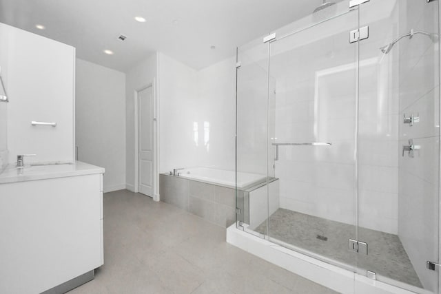 bathroom featuring recessed lighting, a shower stall, vanity, and a bath