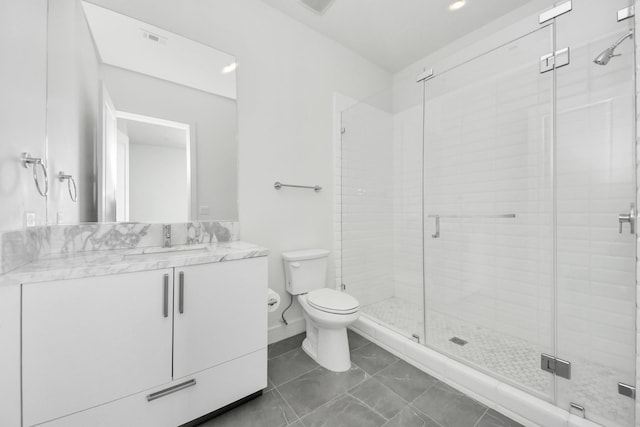 bathroom with toilet, visible vents, a stall shower, and vanity