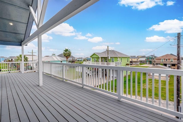 wooden deck featuring a yard and a residential view