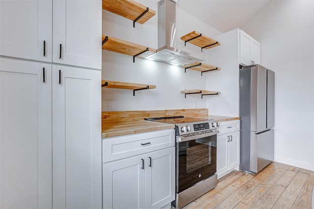 kitchen featuring island range hood, butcher block countertops, white cabinets, appliances with stainless steel finishes, and open shelves