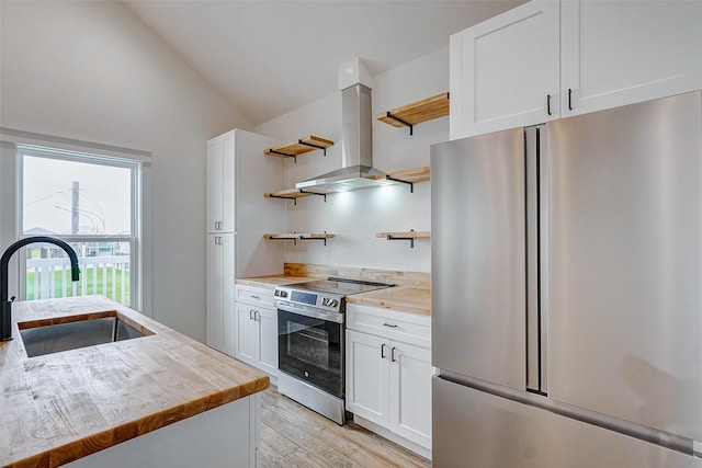 kitchen featuring white cabinets, island exhaust hood, stainless steel appliances, open shelves, and a sink