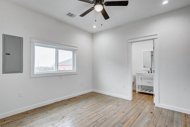 unfurnished bedroom featuring light wood-style flooring, electric panel, visible vents, and baseboards