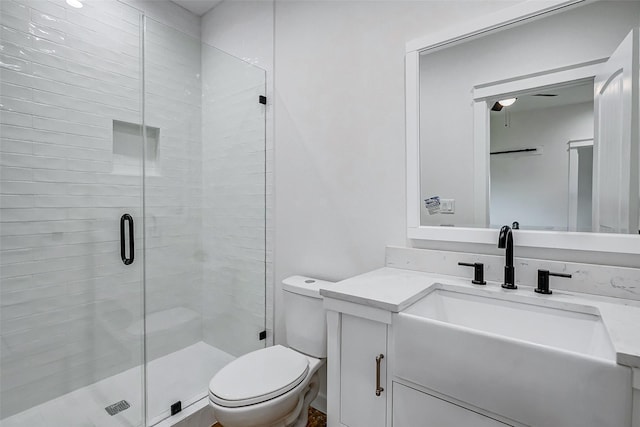 full bathroom with toilet, a stall shower, and vanity