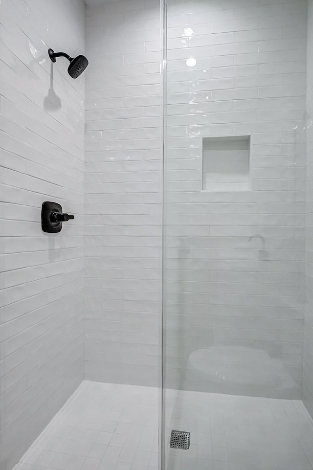 bathroom with a tile shower