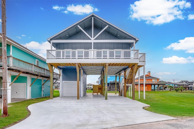 beach home with a carport, stairs, board and batten siding, and a front yard