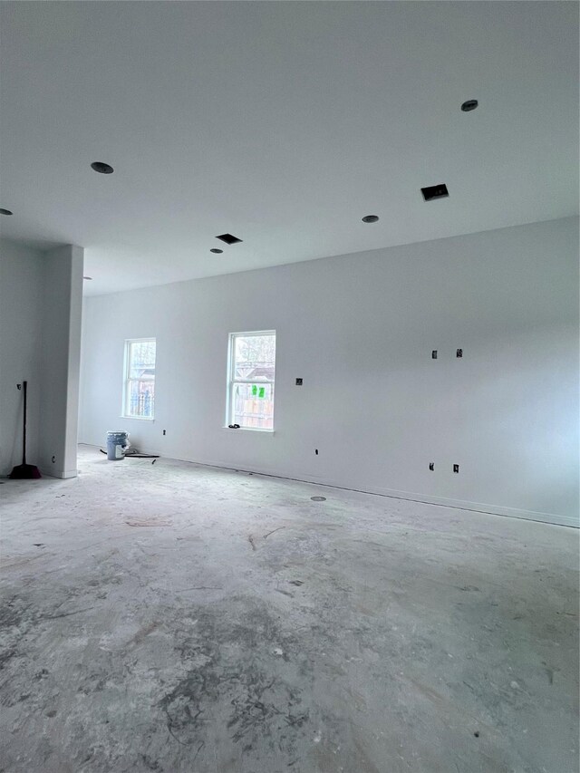 spare room with unfinished concrete floors