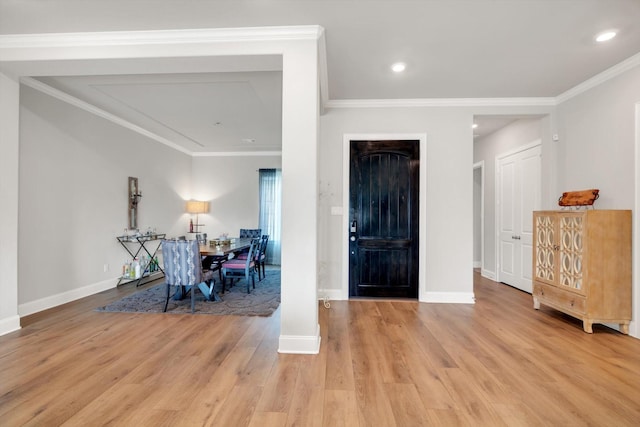 entryway with baseboards, recessed lighting, light wood-type flooring, and crown molding