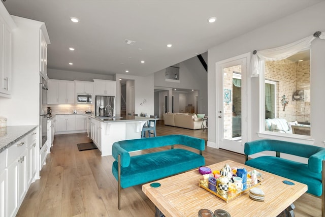 living room with recessed lighting and light wood-style floors