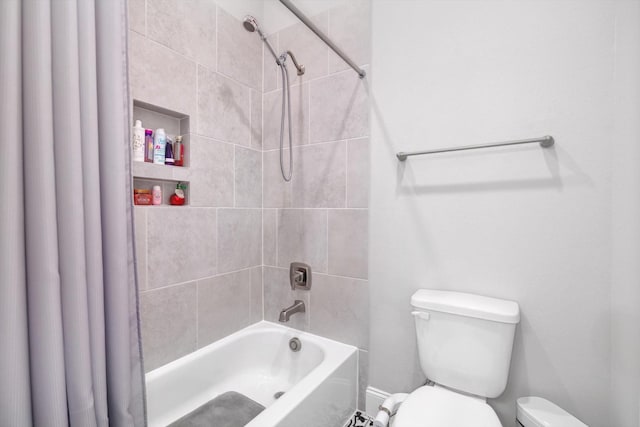 bathroom featuring toilet and shower / bath combo