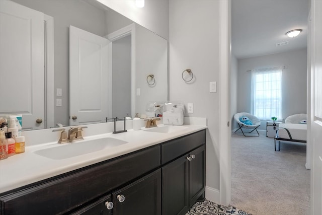 full bathroom featuring double vanity, ensuite bath, visible vents, and a sink