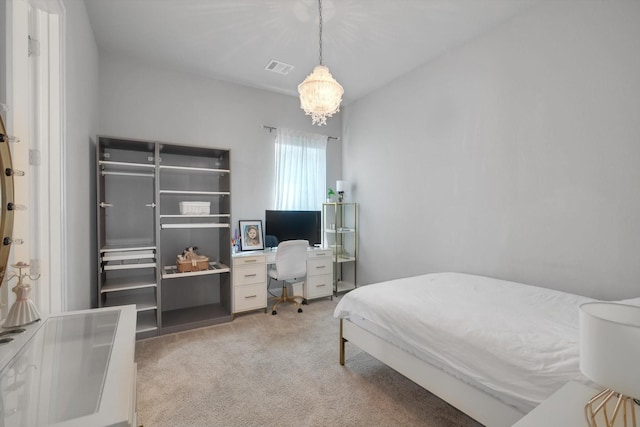 bedroom with light colored carpet, a notable chandelier, and visible vents