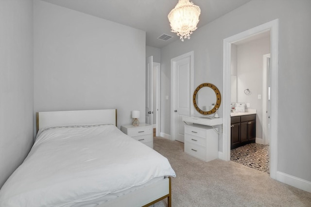 bedroom featuring light colored carpet, visible vents, ensuite bath, a chandelier, and baseboards