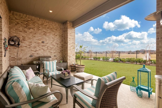 view of patio featuring an outdoor hangout area, grilling area, and fence